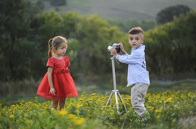 2 kids taking photos