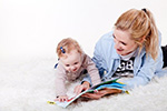 Mother and Daughter reading a book in a photo studio.