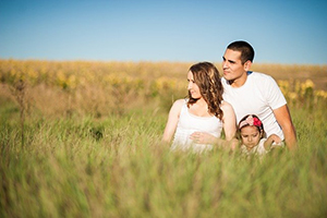 A family in a grassy field.